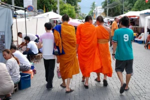 Monks and shoppers at a street market in Chiang Mai