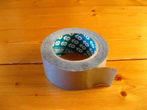 22 Emergency Items That Hold Their Value When Shops Run Empty Emergency items that hold value: a roll of duct tape on a wooden table