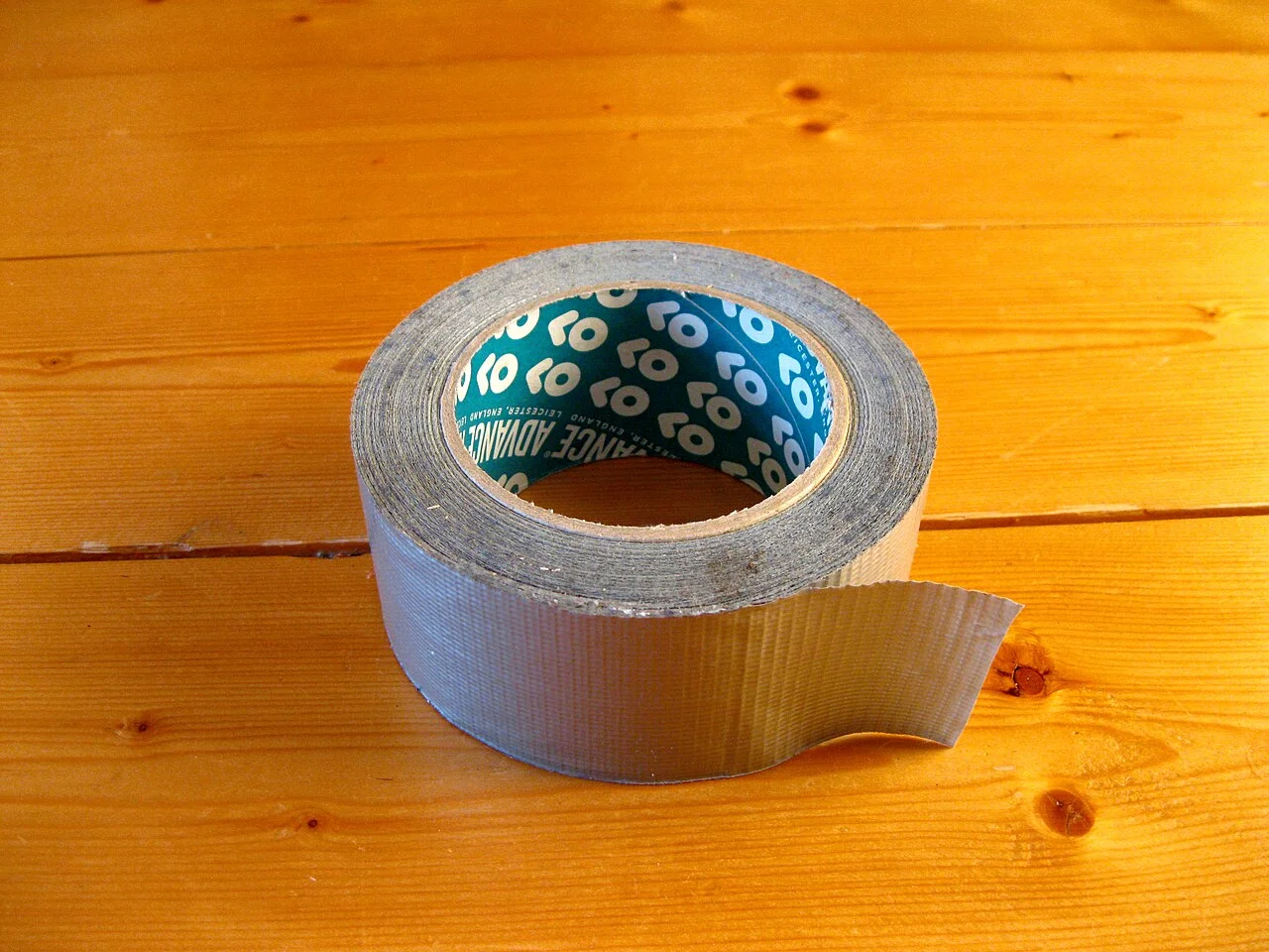 Emergency items that hold value: a roll of duct tape on a wooden table