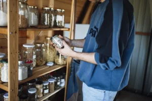 Emergency pantry: wooden shelves with glass jars of grains, beans and spices