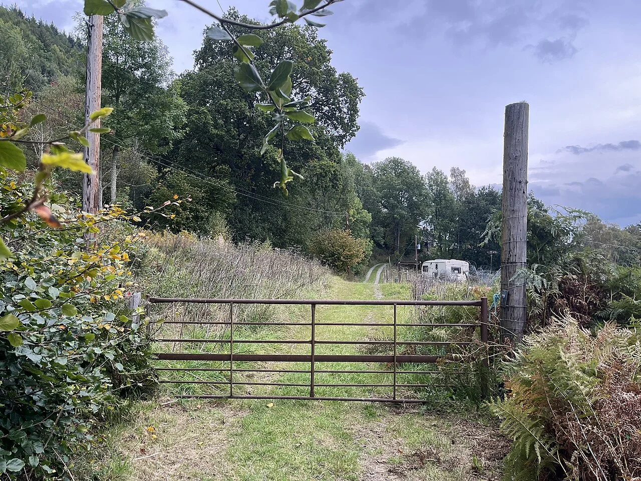 Check land before buying: a pasture gate at the access point to a rural parcel